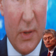 Kremlin spokesman Dmitry Peskov sits in front of an electronic screen during Russian President Vladimir Putin’s annual end-of-year news conference, December 2020. REUTERS/Maxim Shemetov